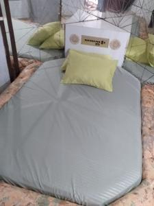 a bed with a pillow on top of it at House1963. in Santo André
