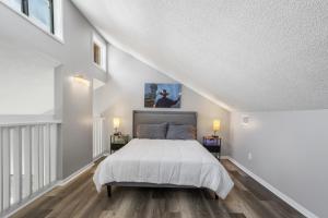 a bedroom with a large bed in a attic at KING BED Well-Located Cozy Townhouse Retreat in Gulfport