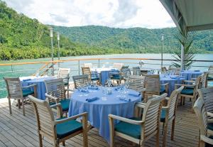 a group of tables and chairs on the deck of a boat at Captain Cook Cruises Fiji in Denarau