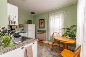 a kitchen with a table and a white refrigerator at Centrally Located With Lake Views in Burlington
