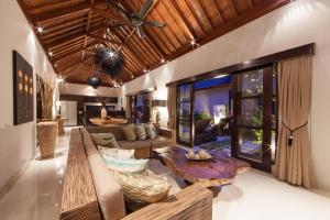 a living room with a couch and a table at Amalika Private Pool Villa Central to Everything in Gili Trawangan