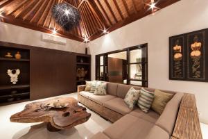 a living room with a couch and a table at Amalika Private Pool Villa Central to Everything in Gili Trawangan