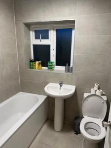 a bathroom with a sink and a toilet and a bath tub at Kriss house in Bristol