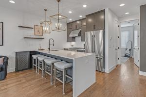 a kitchen with a large island with bar stools at Dixieland Delight @ Skyline in Nashville