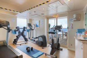 a gym with treadmills and exercise equipment in a room at Captain Cook Cruises Fiji in Denarau