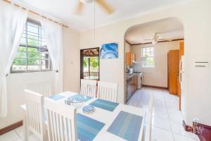 a kitchen and dining room with a table and chairs at 2-Story Townhome with Private Pool, Ideal for Group! in Christ Church