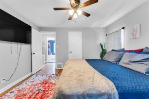 a bedroom with a blue bed and a ceiling fan at Renovated Brooklyn Townhome 9 Miles from Downtown in Brooklyn