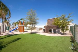 a yard with a playground with a playground at New Townhome with Private Patio, Parking & Pool Onsite in La Paz