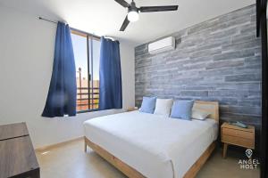a bedroom with a bed and a brick wall at Stylish Townhome with Pool, Patio, and Secure Parking in La Paz +21 photos