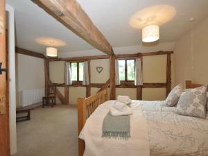 a bedroom with a bed and some windows at 4 Bed in Abergavenny 53959 in Rowlstone