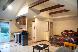 a living room with a bed and a kitchen at Dean Creek Resort in Redway