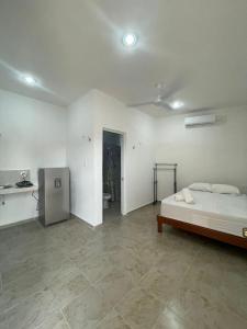 a large white room with a bed in it at Departamento AF2 in Tizimín