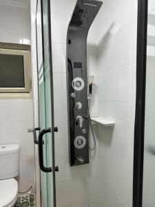 a shower in a bathroom with a toilet at A very luxurious hotel apartment in Obour, the entertainment district, second floor, without an elevator in ‘Ezbet el-Insha