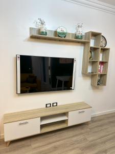 a living room with a television on a wall at A very luxurious hotel apartment in Obour, the entertainment district, second floor, without an elevator in ‘Ezbet el-Insha