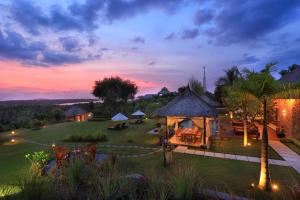 a villa with a gazebo in a garden at night at Villa The Jiwa in Tanjung