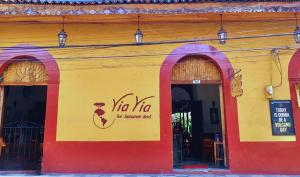 a red and yellow building with a no tin sign on it at ViaVia Leon in León