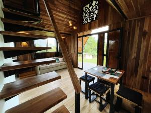 a room with a table and a staircase in a house at Myra Chalets in Bijagua +40 photos