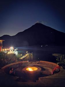 un foyer extérieur de nuit avec une montagne en arrière-plan dans l'établissement PEDACITO DE CIELO, à Santiago Atitlán