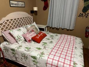 a bed with two pillows and a blanket on it at Acorn Hideaways Canton Delightful Christmas Suite Year Round in Canton