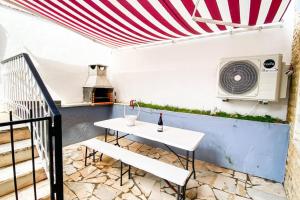 a patio with a white table and a microwave at HU2i - In&Out Carcavelos in Carcavelos