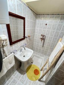 a bathroom with a sink and a mirror at Villa Mouloud réservée aux familles in Arrougou