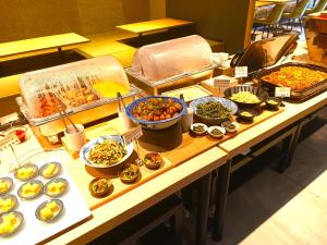 a buffet with many different types of food on a table at Iroha Grand Hotel Kintetsu Nara Ekimae in Nara