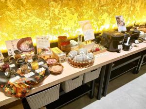a table with many different food items on it at Iroha Grand Hotel Kintetsu Nara Ekimae in Nara