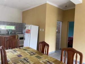 a kitchen with a table and a white refrigerator at Casa en La Puntilla in Belén