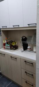 a kitchen with white cabinets and a counter top at Sweethome Mummy@Youthcity Nilai in Nilai