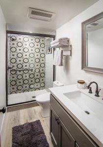 a bathroom with a sink and a toilet and a shower at Whispering Pine Modern Luxe 3 Level 2000 sqft AC View Dogs Village in Lake Arrowhead
