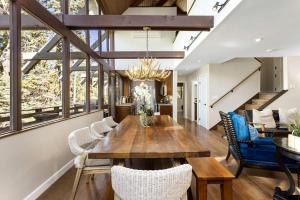 a dining room with a wooden table and chairs at Snowflower Cabin Modern Luxe, 2 Level, 1500 sqft, AC, View, Dogs, Walk to Village in Lake Arrowhead