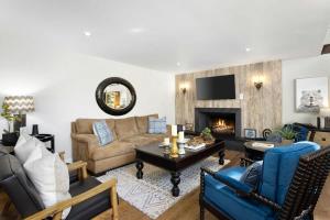 a living room with a couch and a fireplace at Snowflower Cabin Modern Luxe, 2 Level, 1500 sqft, AC, View, Dogs, Walk to Village in Lake Arrowhead