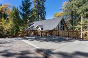 a home with a wooden fence and a house at Snowflower Cabin Modern Luxe, 2 Level, 1500 sqft, AC, View, Dogs, Walk to Village in Lake Arrowhead