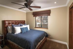 a bedroom with a bed with a ceiling fan at Treetop Cabin, Modern Luxe, 1700 sqft, Deck, View, Dogs, In Village, AC in Lake Arrowhead