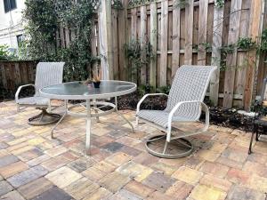 a patio with two chairs and a table and a fence at Comfy and Quiet APT 5 min Walk to Historic Downtown in St. Augustine