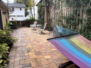 a hammock on a patio with a table at Comfy and Quiet APT 5 min Walk to Historic Downtown in St. Augustine