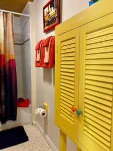 a yellow closet in a bathroom with a shower at Funky Downtown Pad Pets OK Near Intercoastal in Saint Augustine