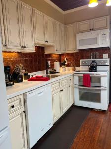 a kitchen with white cabinets and white appliances at Kid and Pet friendly Downtown Home Walk Everywhere in Saint Augustine