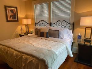 a bedroom with a bed and two lamps and a window at Kid and Pet friendly Downtown Home Walk Everywhere in St. Augustine