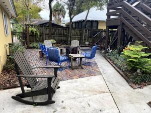 a patio with chairs and a table and a bench at Kid and Pet friendly Downtown Home Walk Everywhere in St. Augustine