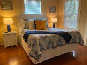 a bedroom with a bed with two lamps on it at Kid and Pet friendly Downtown Home Walk Everywhere in Saint Augustine