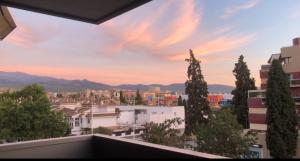 a view of a city from a balcony at Parque lagos granada in Granada