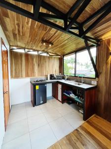 a kitchen with wooden walls and a large counter top at Myra Chalets in Bijagua