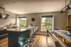a kitchen with a counter with stools in it at Bay View Holiday Apartments in Scarborough