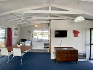 a living room with a table and a kitchen at Sea View Motel - Unit 1 in Kaikoura