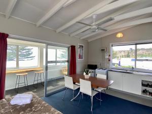 a kitchen and dining room with a table and chairs at Sea View Motel - Unit 1 in Kaikoura