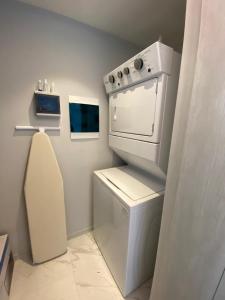 a kitchen with a white stove and a sink at NEW Nautico with Marina View and Rooftop Pool plus Gym in Puerto Vallarta