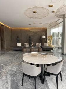 a lobby with tables and chairs in a building at NEW Nautico with Marina View and Rooftop Pool plus Gym in Puerto Vallarta