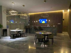 a restaurant with tables and chairs and a bar at NEW Nautico with Marina View and Rooftop Pool plus Gym in Puerto Vallarta