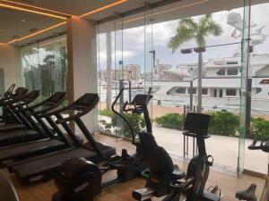 a gym with cardio machines and a large window at NEW Nautico with Marina View and Rooftop Pool plus Gym in Puerto Vallarta